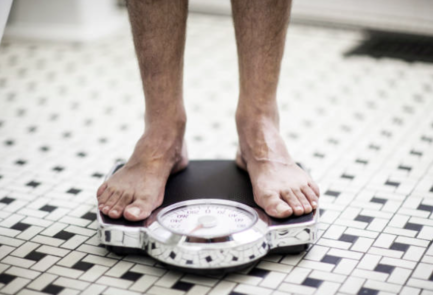 person standing on weigh scales